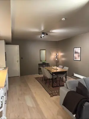 a living room with a table and a couch at Cozy apartment near ski attractions in Geilo