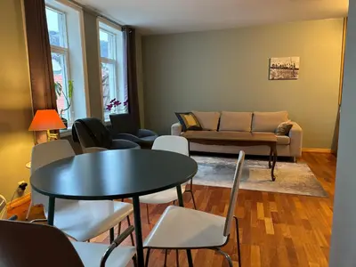 a living room with a table and chairs and a couch at Retro Apartment in Bergen