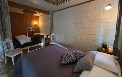 a bedroom with a bed and a brick wall at Casa Grend in Kvam