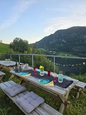a wooden picnic table with a view of a mountain at Casa Grend in Kvam