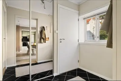 a bathroom with a glass door and a mirror at Leilighet i Sandviken in Bergen