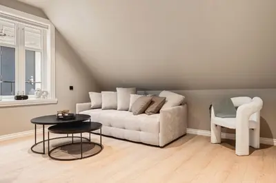 a living room with a couch and a chair at Odda Central Apartment in Odda