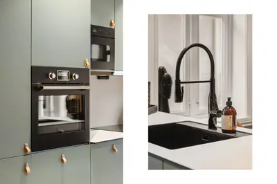 a kitchen with a sink and a black oven at Odda Central Apartment in Odda