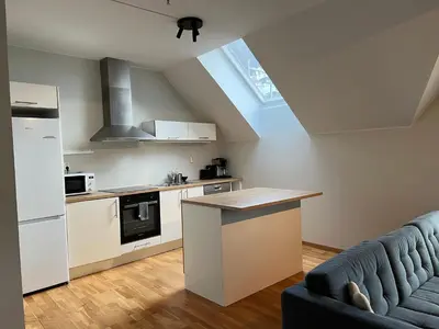 a kitchen with a couch and a counter in a room at Vetrlidsallmenningen 4 in Bergen