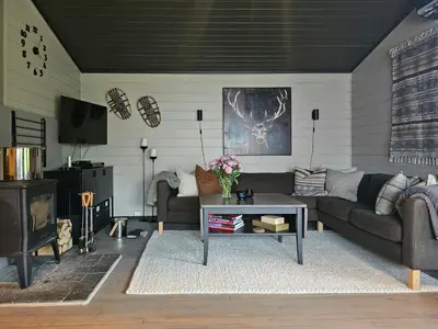 a living room with couches and a coffee table at Mountain Cabin With Magical View And Tranquil Lake in Matre