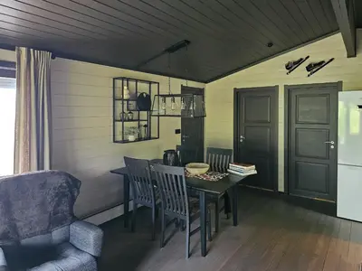 a dining room with a table and a chair at Mountain Cabin With Magical View And Tranquil Lake in Matre