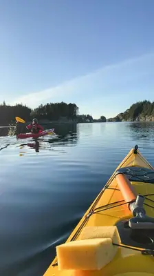 a couple of people in a kayak on the water at Charming Seaside Cabin With Amazing View in Hardbakke
