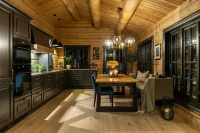 a kitchen with a wooden ceiling and a wooden table at Modern Log Cabin With Hot Tub And Sauna in Veggli