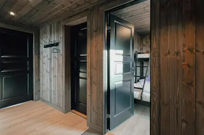 an open door in a room with a bedroom at Charming Summer Farm Hut At Sjusjøen in Torpo