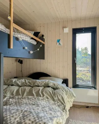 a bedroom with a bed and a window at Stylish Mountain Cabin In Hallingdalen in Flå