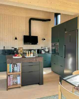 a kitchen with green cabinets and a counter top at Stylish Mountain Cabin In Hallingdalen in Flå