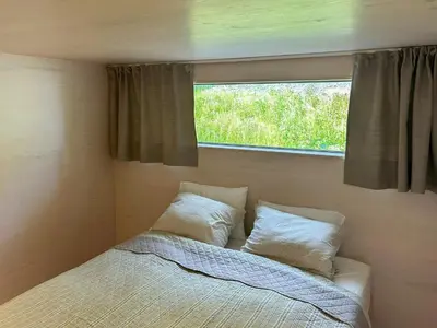 a bed in a small room with a window at New Cabin By Tyrifjorden For Relaxing Holidays in Gjesval