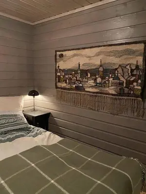 a bedroom with a painting on the wall and a bed at Charming and cozy cabin in Geilo in Geilo