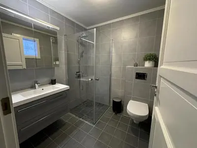 a bathroom with a shower and a sink and a toilet at Modern 2-Bedroom Apartment In Ideal Location in Beitostøl