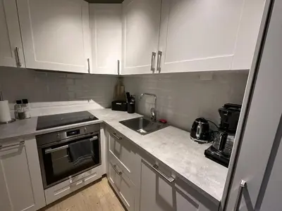 a kitchen with white cabinets and a sink at Modern 2-Bedroom Apartment In Ideal Location in Beitostøl