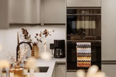 a kitchen with an oven with a vase of flowers at Luxurious Villa in the heart of Bergen with private parking in Bergen