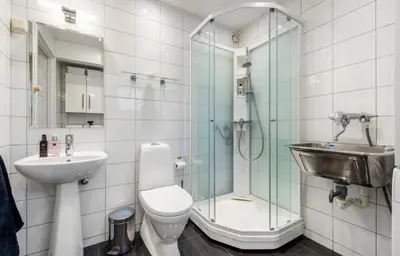 a bathroom with a shower and a toilet and a sink at SKI VM TRONDHEIM 2025- Private home in Tiller