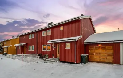 a group of red buildings with snow on the ground at SKI VM TRONDHEIM 2025- Private home in Tiller