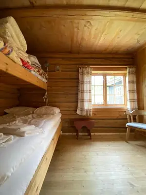 a bedroom with two bunk beds and a window at Brattland Sæter in Strond