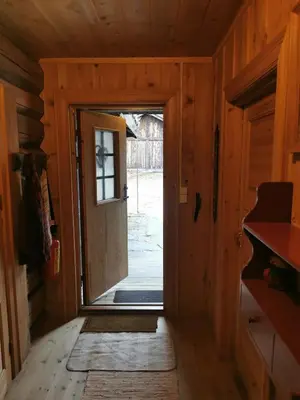 an open door in a wooden room with a doorway at Brattland Sæter in Strond