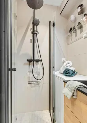 a shower in a bathroom with a glass door at Lys og koselig leilighet leies ut til Ski VM 2025 in Trondheim