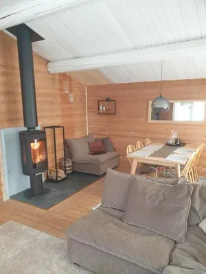 a living room with a couch and a fireplace at Koselig hytte på Beito in Beitostøl