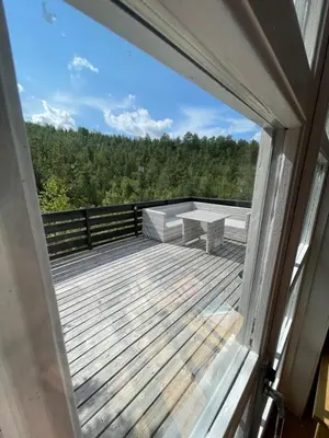 a view from a window of a deck with a bench at Koselig hytte på Beito in Beitostøl