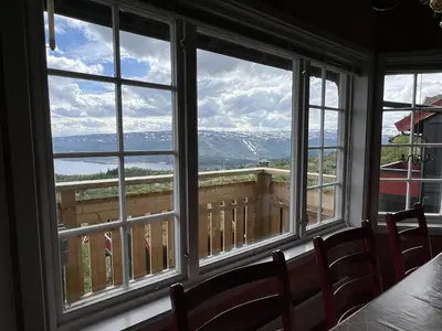 a room with a window with views of the mountains at Ski-In Ski-Out Cozy Retreat With Mountain Views in Beitostøl