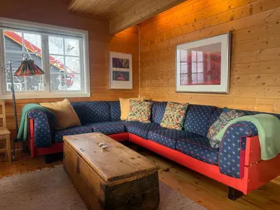 a living room with a couch and a table at Ski-In Ski-Out Cozy Retreat With Mountain Views in Beitostøl