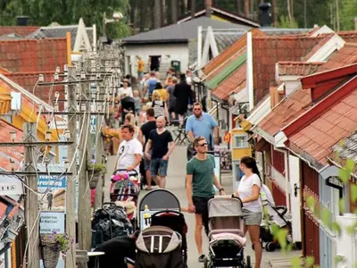 a group of people walking down a street with buildings at Apartment at Hafjell by Gaia ski-in out in Hafjell