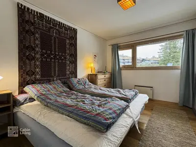 a bedroom with a bed with a large window at Apartment at Hafjell by Gaia ski-in out in Hafjell