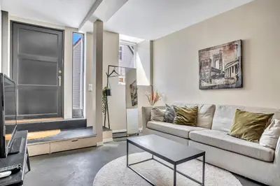 a living room with a couch and a table at Bryggen Nest in Bergen