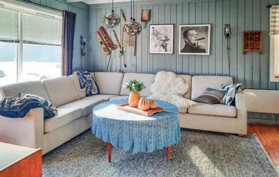 a living room with a couch and a table at Stunning Home In Øydegard in Nastad