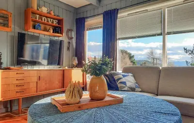 a living room with a table with vases on it at Stunning Home In Øydegard in Nastad
