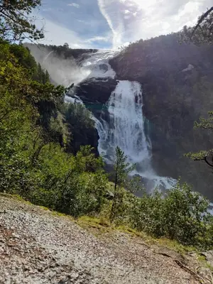 a view of a waterfall in a valley at Vassel gård in Herand