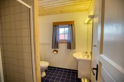 a bathroom with a toilet and a sink at Nostalgic Cabin With 3 Br, Fireplace, And Terrace in Beitostøl
