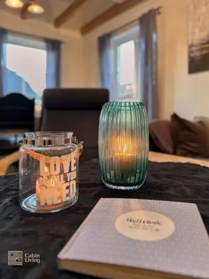 a table with a laptop and a glass vase on it at Modern apartment Hovden ski in-out x-skiing, 2 bathrooms and balcony in Hovden