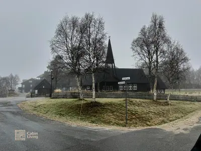 a large black building on the side of a road at Modern apartment Hovden ski in-out x-skiing, 2 bathrooms and balcony in Hovden
