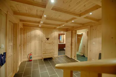 a large room with wooden walls and a wooden ceiling at Peaceful Cabin Close To Beitostølen Center&Nature in Beitostøl