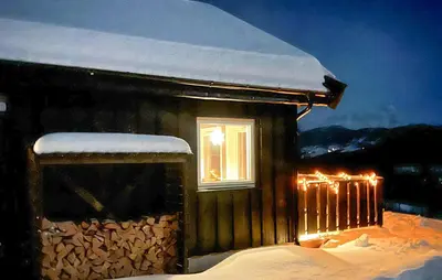 a building with a window with snow on it at Moderne Hytte Midt I Skibakken in Ryfoss