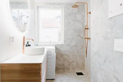 a white bathroom with a sink and a shower at New Apartment in Historical street in Bergen
