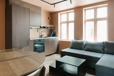 a living room with a couch and a table at New Apartment in Historical street in Bergen