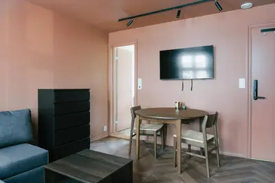 a living room with a table and a couch at New Apartment in Historical street in Bergen