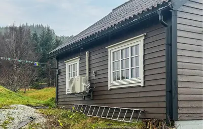 a house with a window and a radiator on the side of it at 1 Bedroom Beautiful Home In Korssund in Korssund