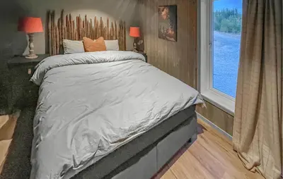 a bed in a small room with a window at 4 Bedroom Gorgeous Home In Koppang in Koppang