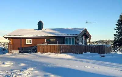 a house with a fence in the snow at Lovely Home In Sjusjøen With Wifi in Sjusjøen
