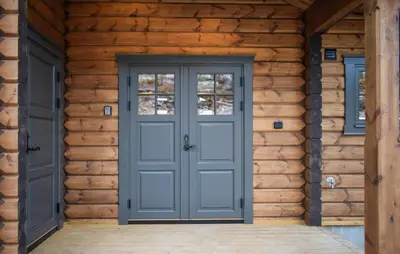 a blue door on a wooden house at Amazing Home In Koppang in Koppang