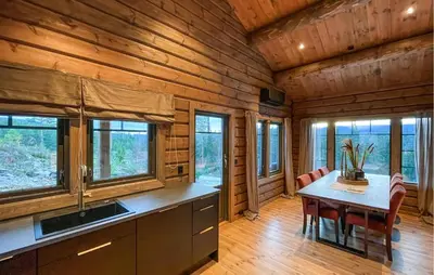 a kitchen with a table and chairs in a cabin at Amazing Home In Koppang in Koppang