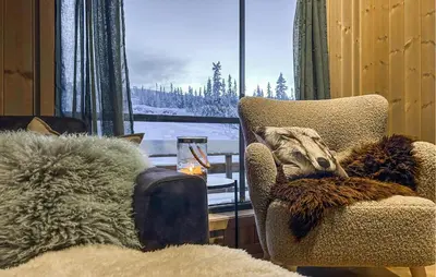 a living room with a chair and a window at Stunning Home In Flå With Sauna in Skadeland
