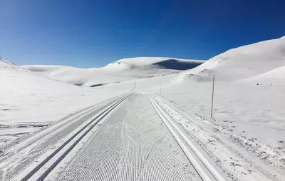 a snow covered road with tracks in the snow at Stunning Home In Flå With Sauna in Skadeland